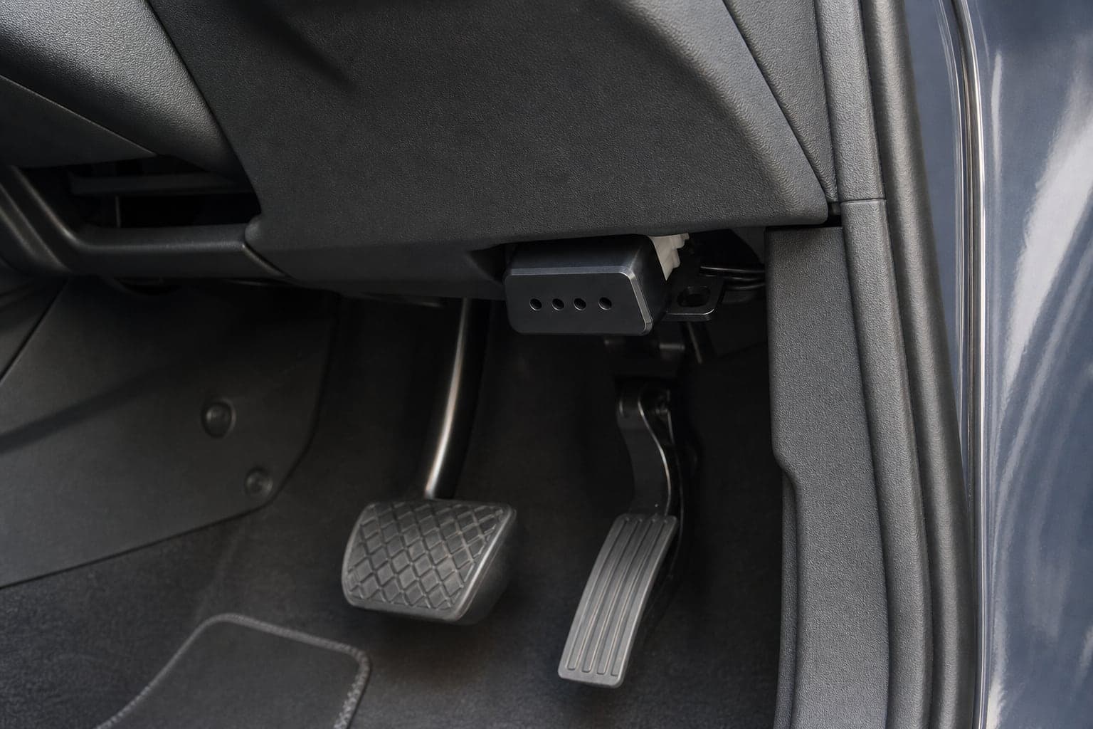 Illustrative AXLEWARD campaign render showing OBD GUARD fitted beneath a vehicle dashboard
